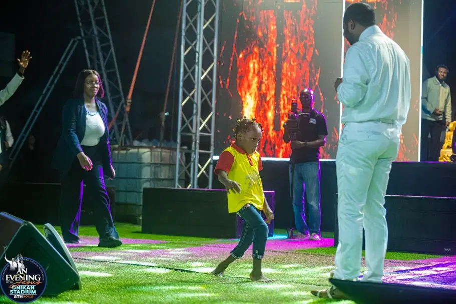 A young girl walking on stage after being prayed for
