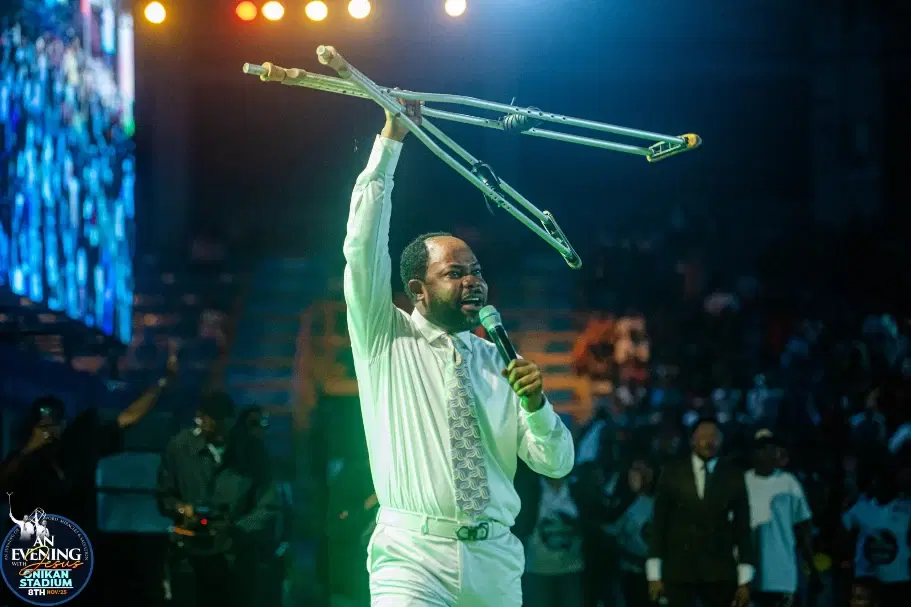 Prophet Isaiah Macwealth raising crutches over a healed crowd at Onikan Stadium