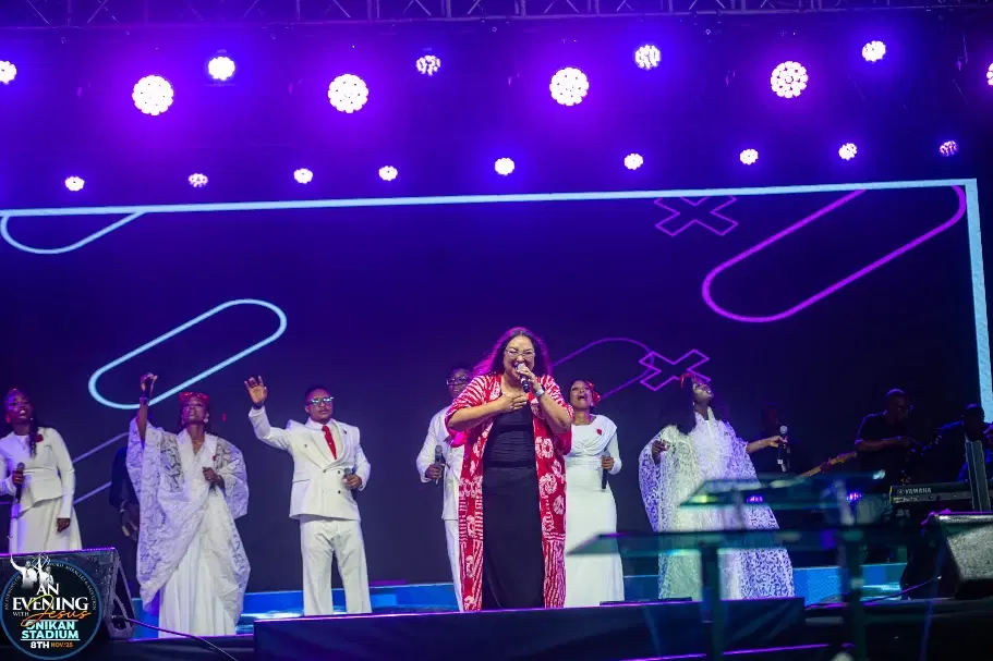 A minister singing with the choir during worship