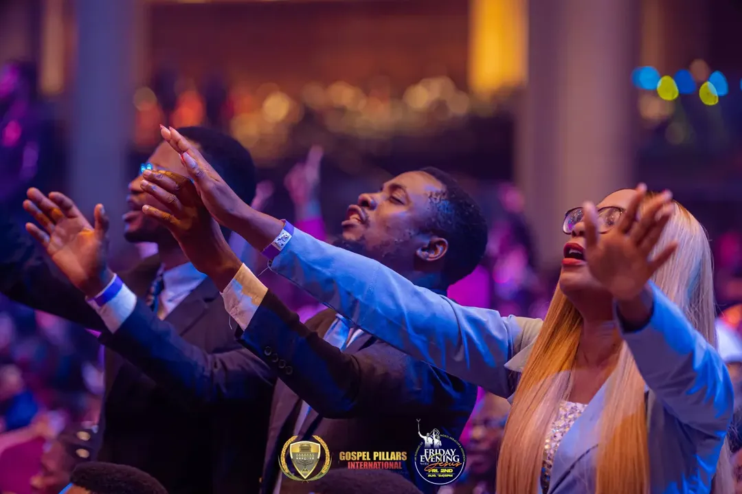 Worshippers with hands raised in praise