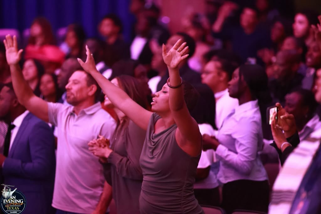 Worshippers lifting their hands at An Evening With Jesus, Texas