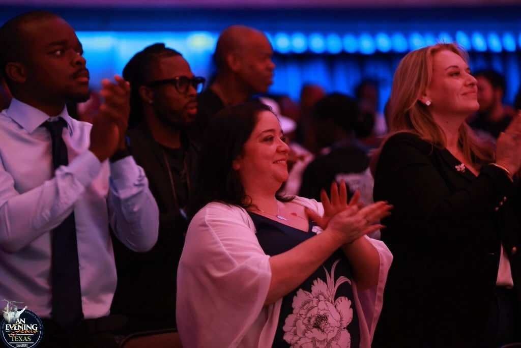 A diverse congregation clapping in worship at An Evening With Jesus, Texas